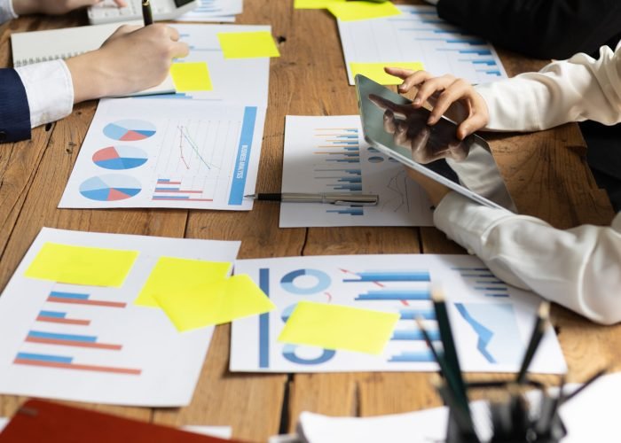 Business meeting, brainstorming discuss analysis of business market growth charts for strategic planning and investment. Cooperation and collaboration of people in the organization.