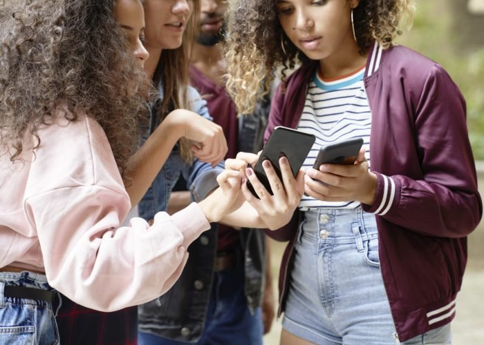 Group of young people staring at cell phones