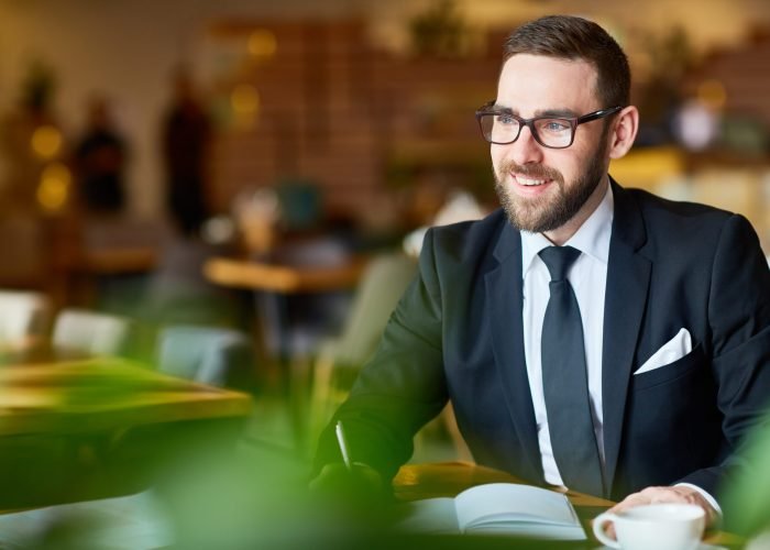 Happy broker writing down working ideas